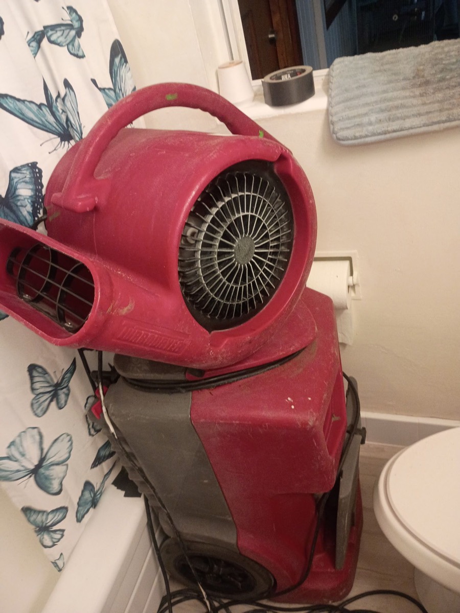 Air mover restoration equipment drying a bathroom after water damage in Jacksonville, FL